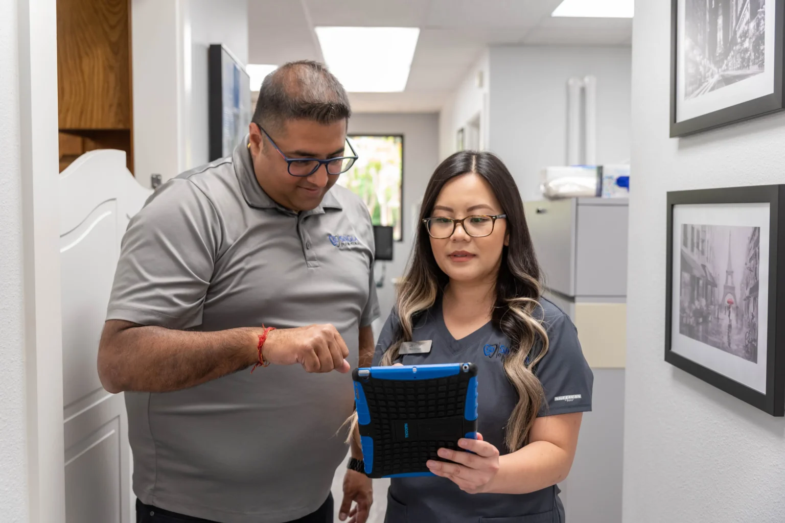 Dr. Singla speaking to a member of the Singla dental team